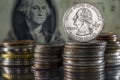 Stack of Coins Quarter Dollar on top George Washington Overlooking from Dollar Bill Background Royalty Free Stock Photo