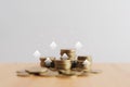 Coins stacking, in soft focus, with up arrow on wooden desk for financial banking increase interest rate or mortgage investment Royalty Free Stock Photo