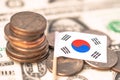 Stack of coins with South Korea flag on USA America dollar banknotes Royalty Free Stock Photo