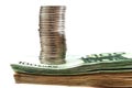 Stack of coins on a stack of euro banknotes isolated on a white background. Side view. Close-up. Royalty Free Stock Photo