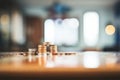 a stack of coins teetering on the edge of a table Royalty Free Stock Photo