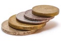 A stack of 5 coins of varying denomination and from varying countries.