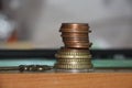 Stack of coins and vintage key. Business profit, accounting and seeking for gain concept. Money value and currency exchange Royalty Free Stock Photo