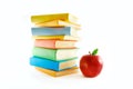 A stack of color books and apple