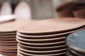 Stack of color ceramic plates in a store. Varieties of tableware. Set of kitchen plates on a store shelf Royalty Free Stock Photo