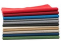 Stack of colored fabrics isolated on white background Royalty Free Stock Photo
