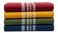 Stack of colored fabrics with patterned border isolated on white background Royalty Free Stock Photo