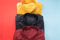 Stack of colored men shirt on red and blue background Royalty Free Stock Photo