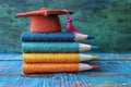 Stack of Colored Pencils With Graduation Cap. Generative AI