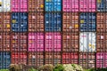 Stack of colored shipping containers in sunlight