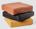 Stack of colorful artisanal leather cushions with woven texture Royalty Free Stock Photo