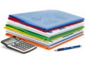 Stack of colorful binders with calculator and pen isolated on white background Royalty Free Stock Photo