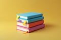 Stack of colorful books with bookmarks rests on plain yellow background. These books represent learning, knowledge acquisition. Royalty Free Stock Photo