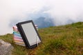 Stack of colorful books and electronic book reader Royalty Free Stock Photo