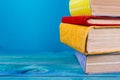 Stack of colorful books, grungy blue background, free copy space Royalty Free Stock Photo