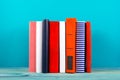 Stack of colorful books, grungy blue background, free copy space Royalty Free Stock Photo