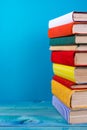 Stack of colorful books, grungy blue background, free copy space Royalty Free Stock Photo