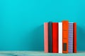 Stack of colorful books, grungy blue background, free copy space Royalty Free Stock Photo