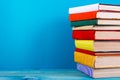 Stack of colorful books, grungy blue background, free copy space Royalty Free Stock Photo