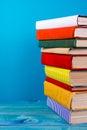 Stack of colorful books, grungy blue background, free copy space Royalty Free Stock Photo