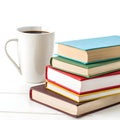 Stack of colorful books with coffee mug isolated on white background Royalty Free Stock Photo