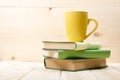 Stack of colorful books, open book and cup on wooden table. Back to school. Copy space Royalty Free Stock Photo