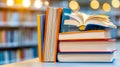 Stack of Colorful Books with Open Pages on Table in Library With Bright Royalty Free Stock Photo