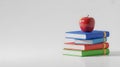 Stack of Colorful Books with Red Apple on Top Royalty Free Stock Photo