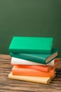 Stack of colorful books on wooden surface Royalty Free Stock Photo