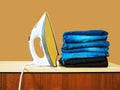 Stack of colorful clean towels  on white background. Ironing clothes on ironing board. Stack of clean towels on table. Colored tow Royalty Free Stock Photo