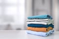 Stack of colorful clothes. Pile of clothing on table empty space background Royalty Free Stock Photo