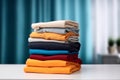 Stack of colorful clothes. Pile of clothing on table empty space background. Laundry and household. Royalty Free Stock Photo