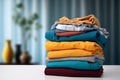 Stack of colorful clothes. Pile of clothing on table empty space background. Laundry and household. Royalty Free Stock Photo