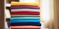 Stack of colorful clothes. Pile of clothing on table empty space background. Laundry and household Royalty Free Stock Photo