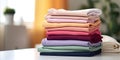 Stack of colorful clothes. Pile of clothing on table empty space background. Laundry and household Royalty Free Stock Photo