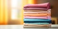 Stack of colorful clothes. Pile of clothing on table empty space background. Laundry and household