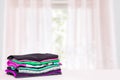 Stack colorful clothes. Pile of folded cotton t-shirts or shirts on a bright table with space for your display product montage Royalty Free Stock Photo