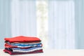 Stack colorful clothes. Pile of folded cotton t-shirts or shirts on a bright table with space for your display product montage Royalty Free Stock Photo