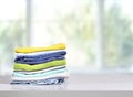 Stack of colorful clothes on table empty copy space,cotton clothing pile Royalty Free Stock Photo
