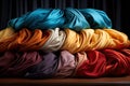 A stack of colorful cloths sitting on top of a wooden table created with generative AI technology Royalty Free Stock Photo