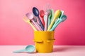 stack of colorful cooking utensils on a pastel background