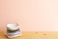 Stack of colorful dishes on wooden table Royalty Free Stock Photo