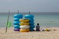 Stack of colorful floating swim ring on the beach, rubber swimming tubes.