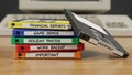 Stack of Colorful Floppy Disks Labeled with Various Data Categories on a Desk Royalty Free Stock Photo