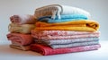 Stack of colorful folded blankets on a white surface Royalty Free Stock Photo