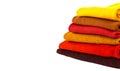 Stack of colorful folded sweaters isolated on white background with copy space. Royalty Free Stock Photo