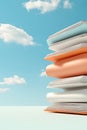 Stack of colorful folders against blue sky with white clouds, symbolizing project organization and remote work. Royalty Free Stock Photo