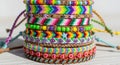 A stack of colorful friendship bracelets featuring intricate woven patterns and bead Royalty Free Stock Photo