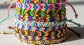 Stack of colorful friendship bracelets featuring woven patterns and various Royalty Free Stock Photo