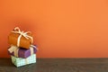 Stack of colorful gift boxes on wooden table. red wall Royalty Free Stock Photo